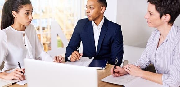 Three colleagues reviewing an application together
