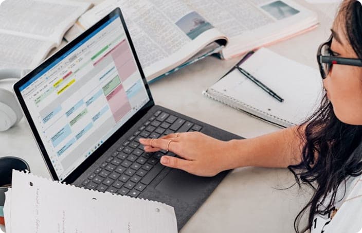 A student working to a study timetable on her laptop