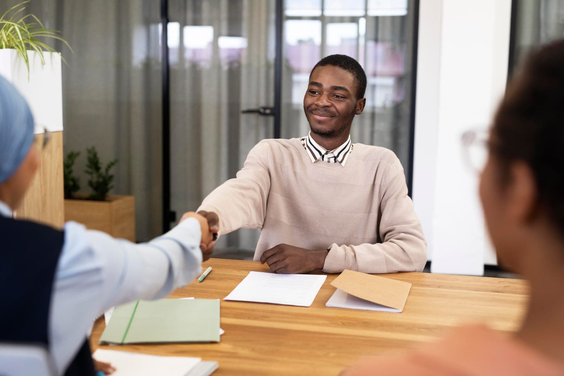 A nurse meeting an adviser to plan their move to the UK
